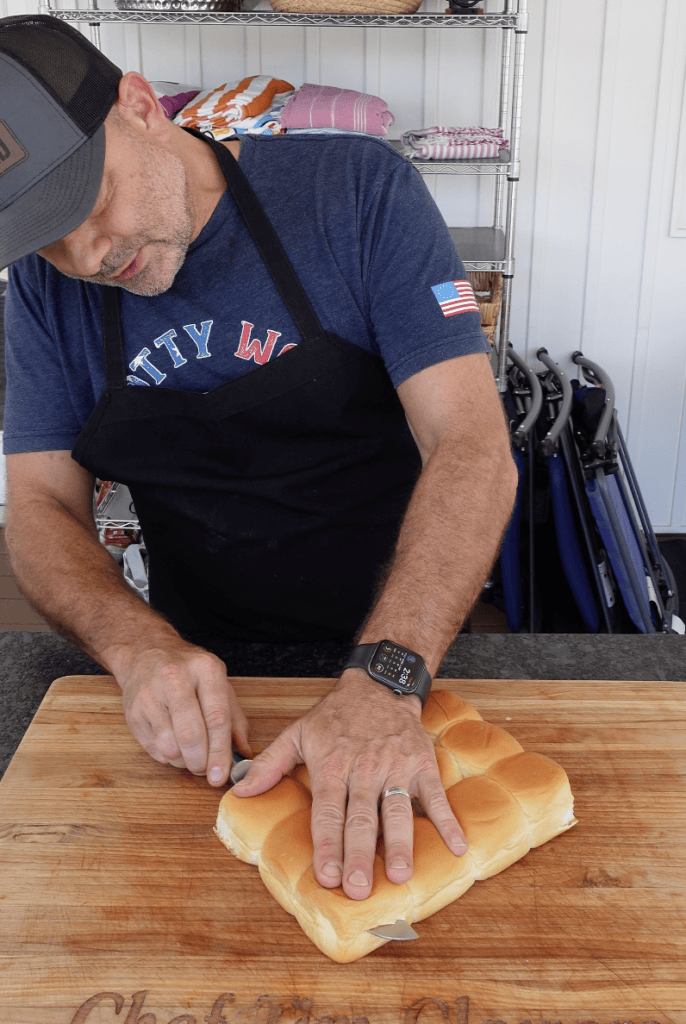 Slicing Hawaiian buns in half.