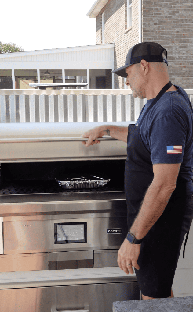Tim cooking on a coyote grill.