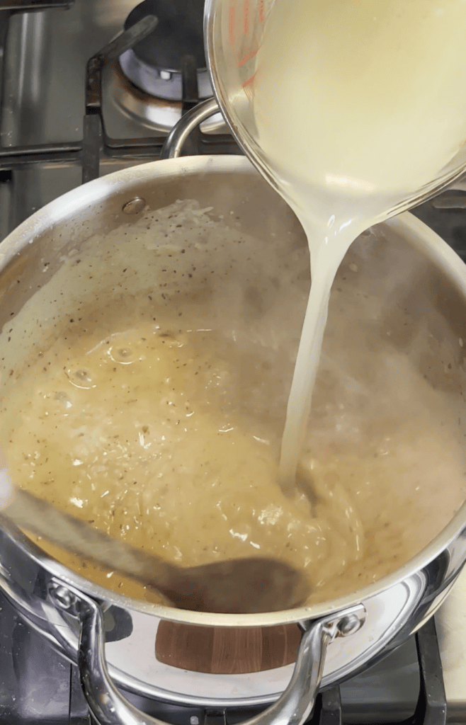 Liquid going into a pot of soup.