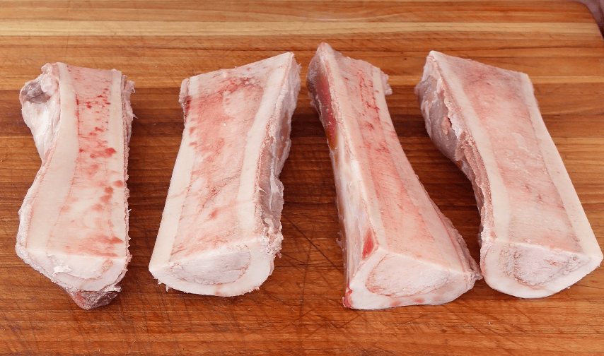 4 pieces of bone marrow on a board.