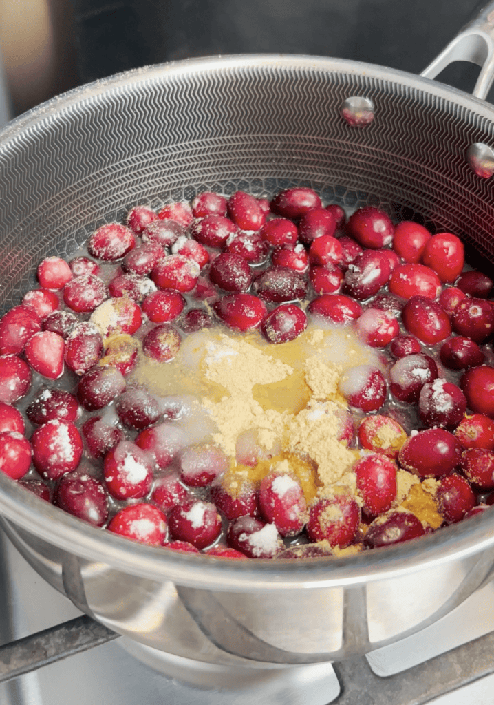 Cranberries and seasoning in a pot.