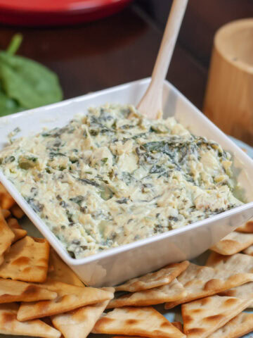 Spinach Artichoke dip with pita chips and spinach.