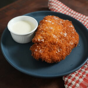 Chicken Katsu on a plate with ranch.