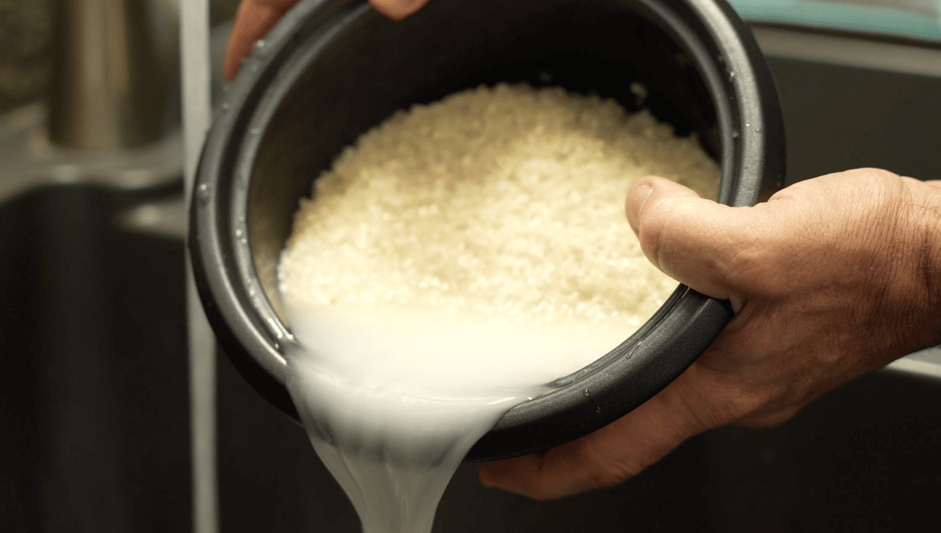 Rinsing off rice prepping it to cook.