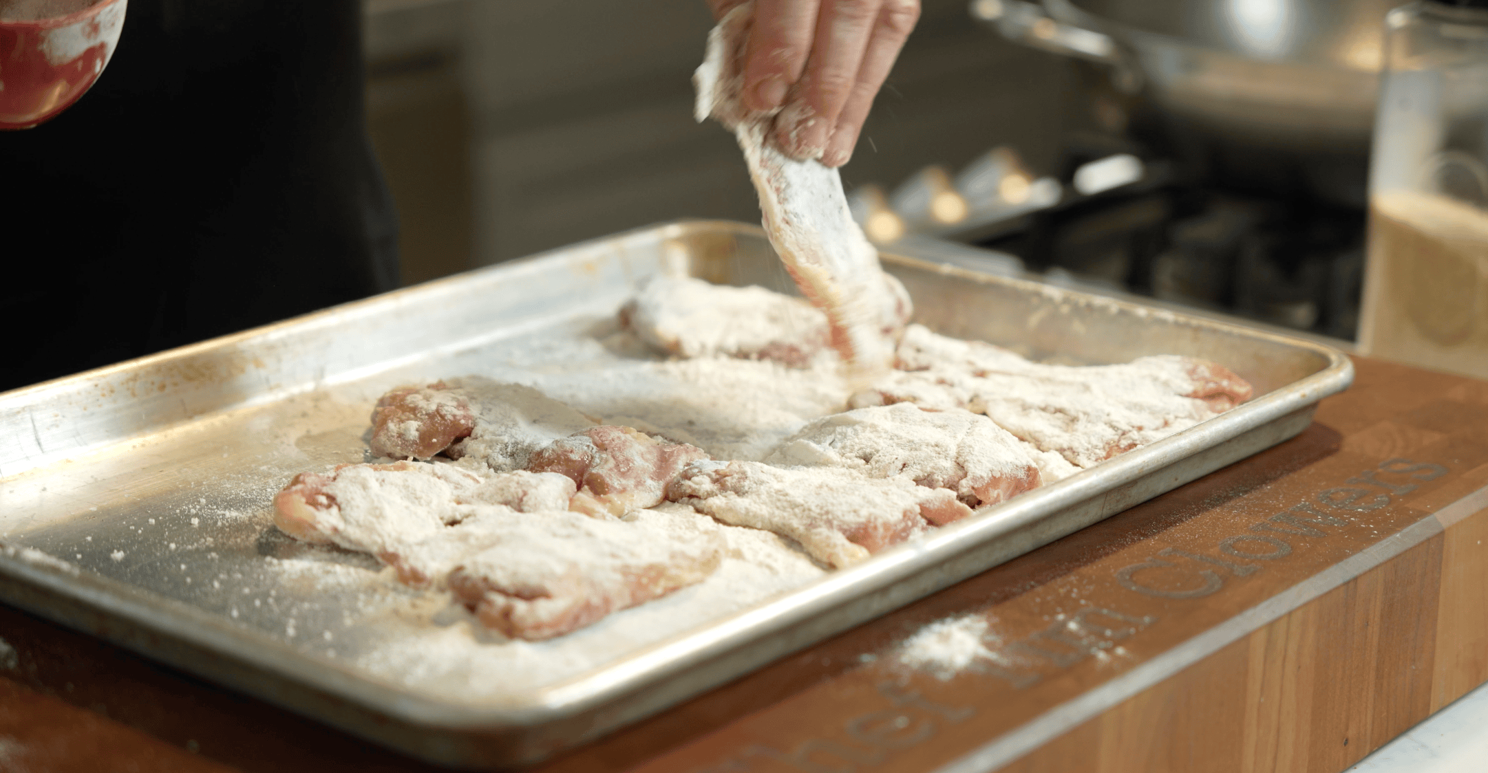 Chicken thighs on a baking sheet.