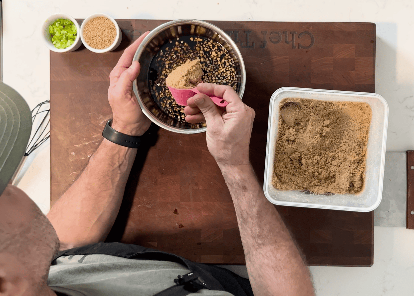 Brown sugar going into a teriyaki sauce.