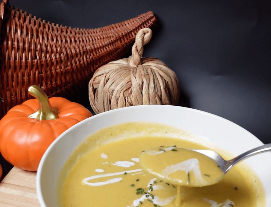 A scoop of pumpkin soup.