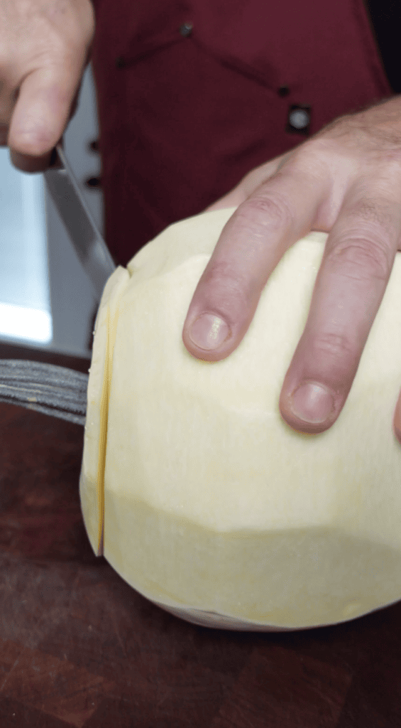 Cutting out the top of the pumpkin.