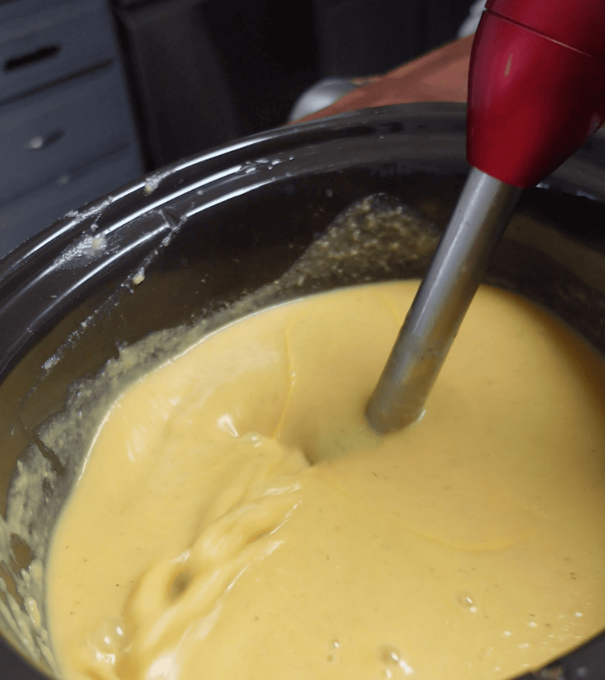 An Immersion Blender blending soup.
