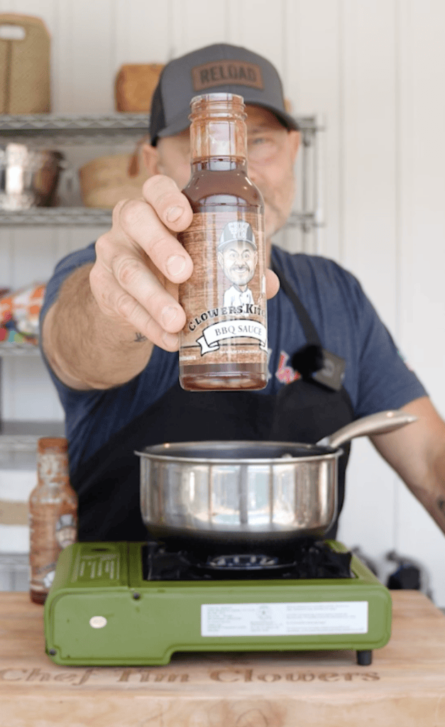 Tim holding up his BBQ Sauce.