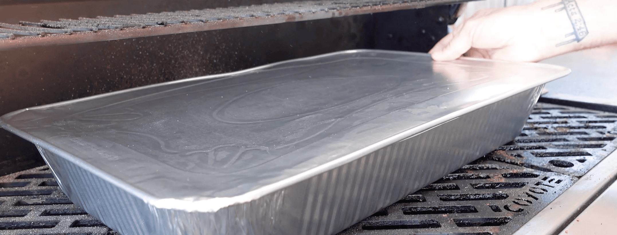 An aluminum pan going onto the smoker.