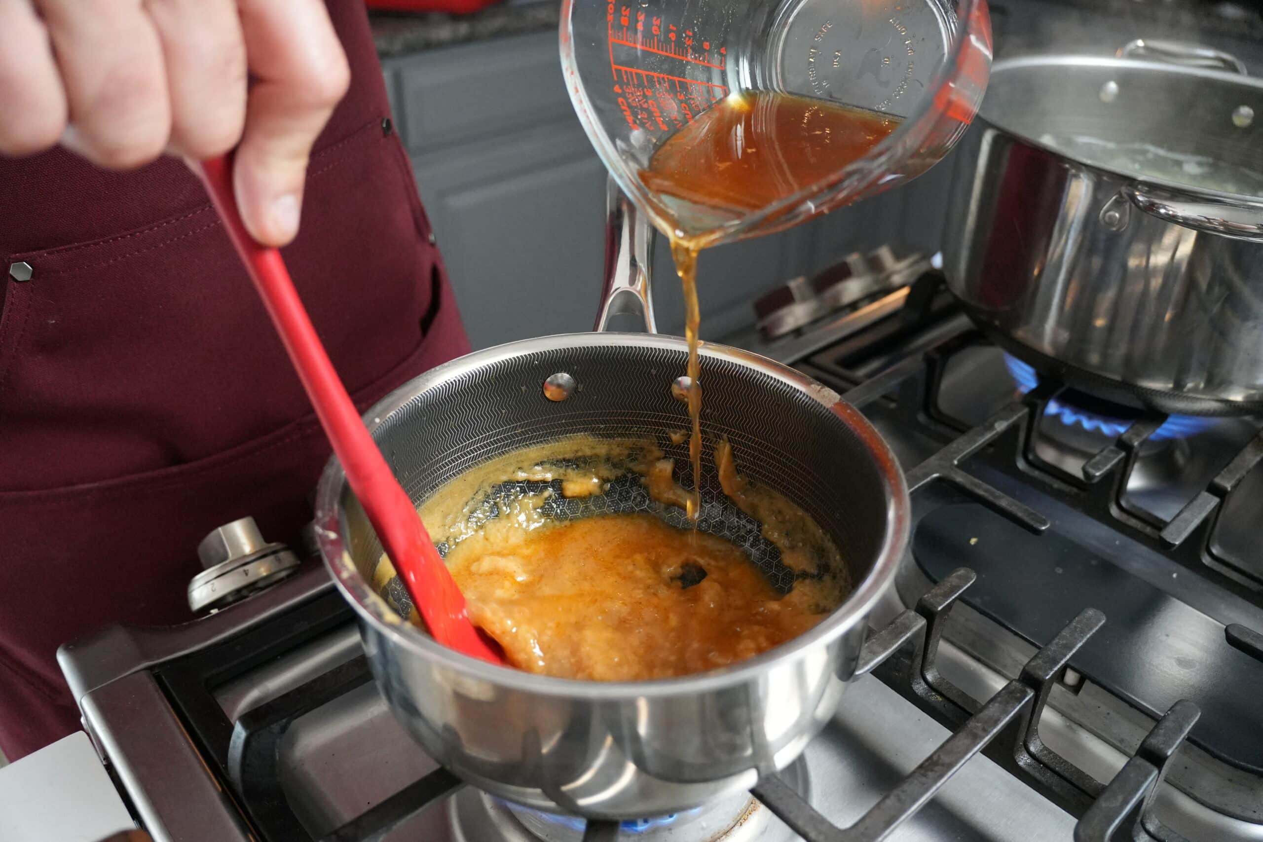 Stirring gravy in stock pot.