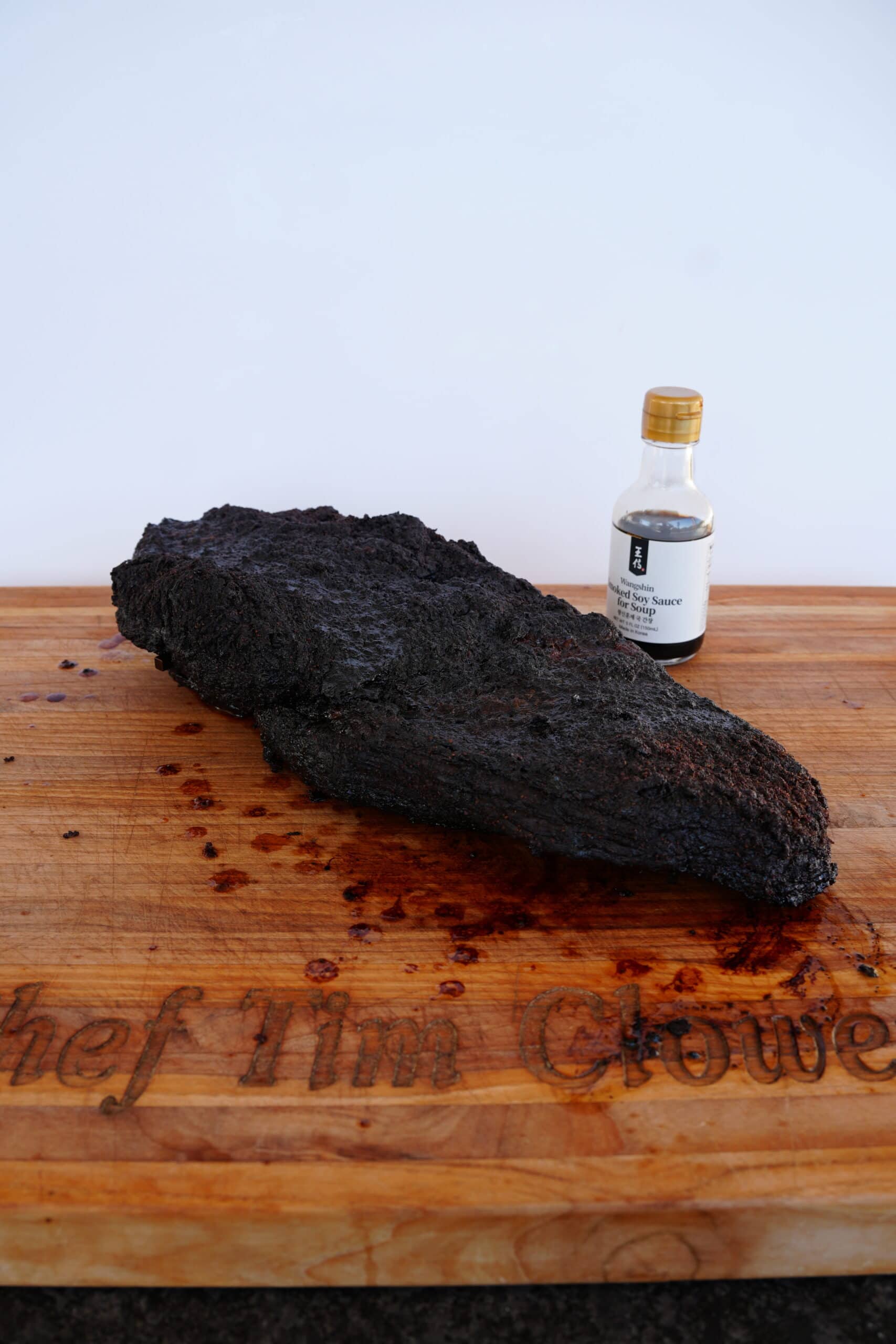 Smoked brisket next to soy sauce.