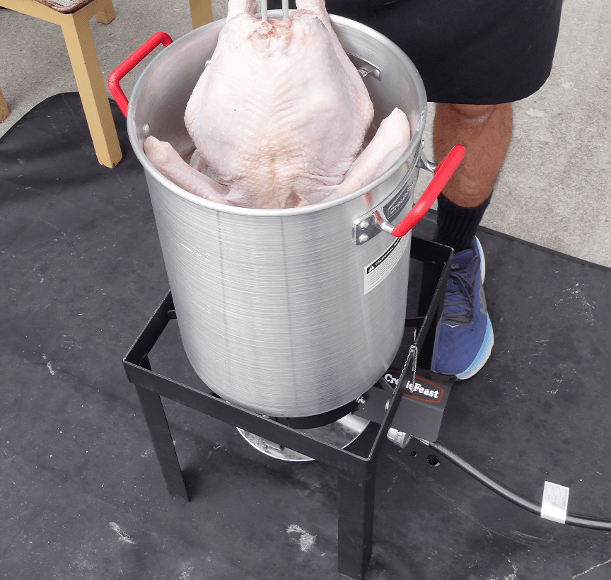 Turkey going into fryer.