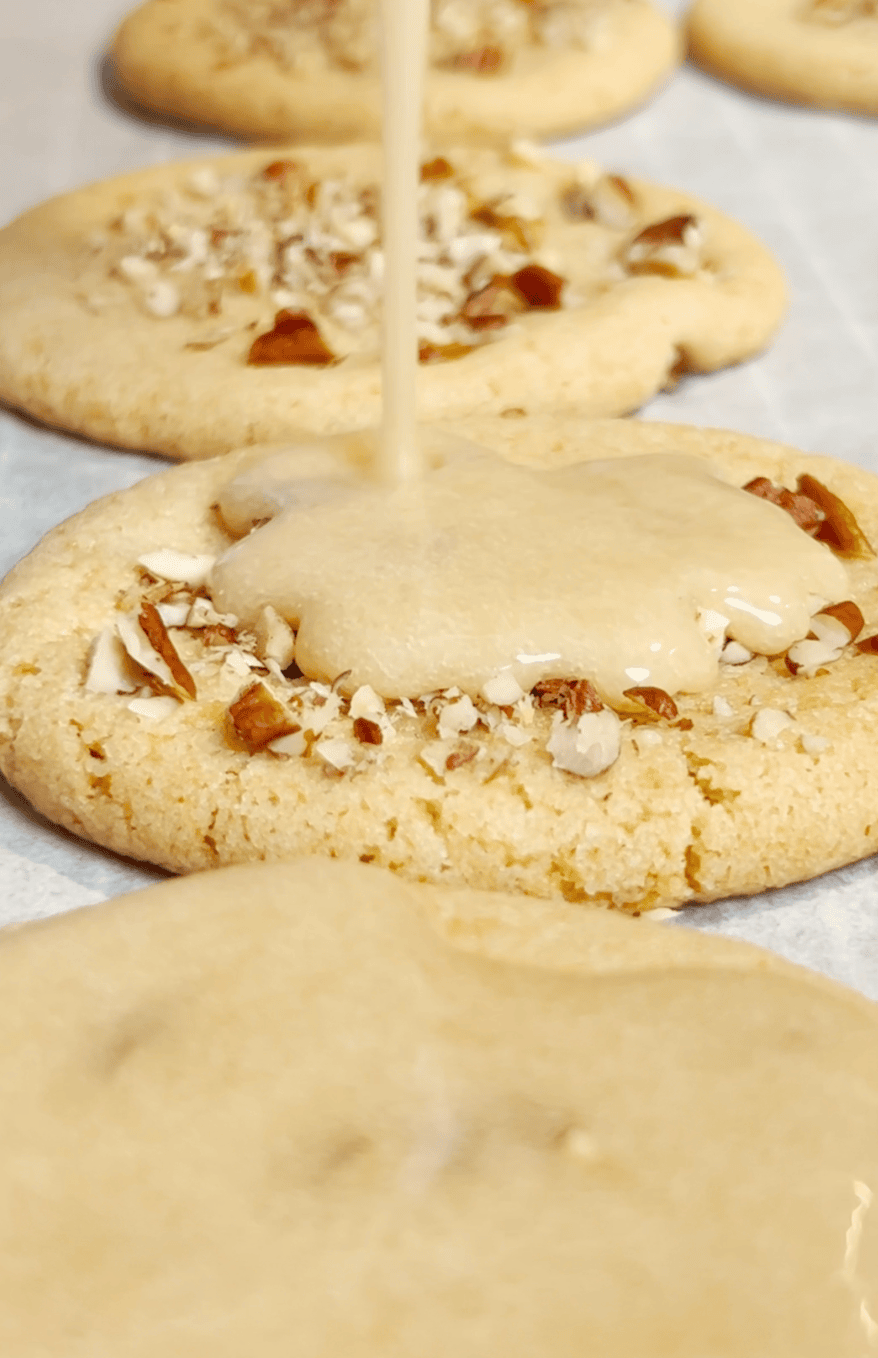 Icing over praline cookies.
