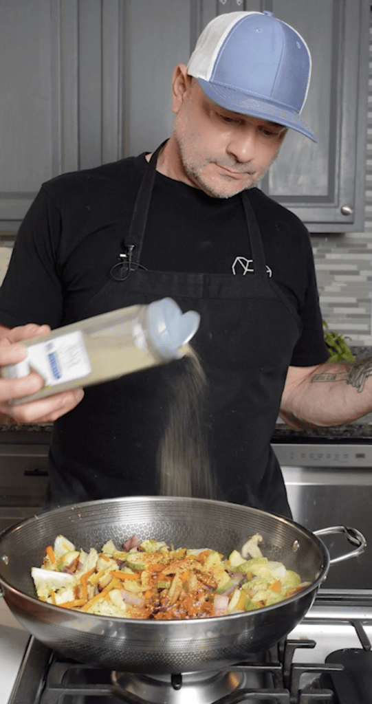 Seasoning Vegetables in skillet.