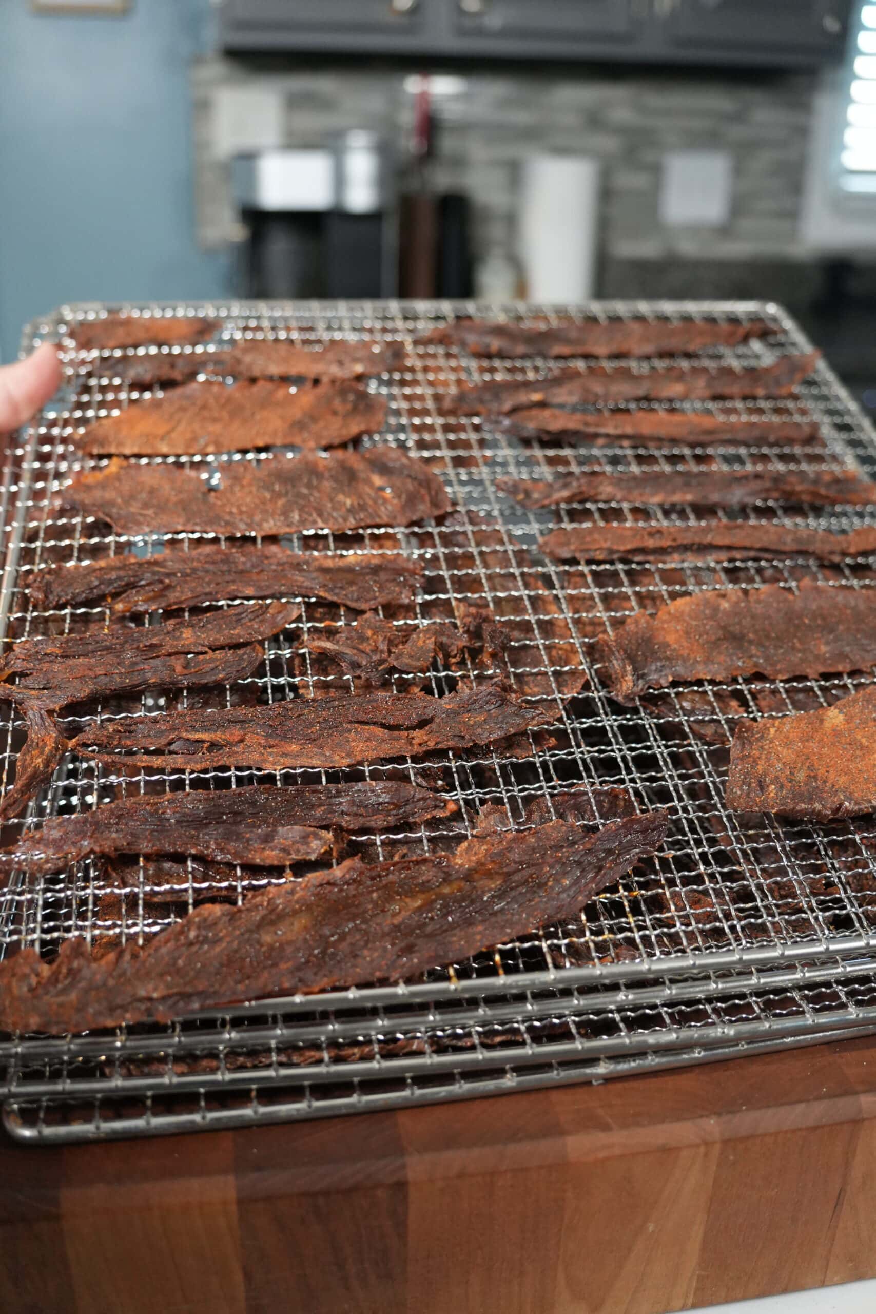 Beef jerky on dehydrating racks.