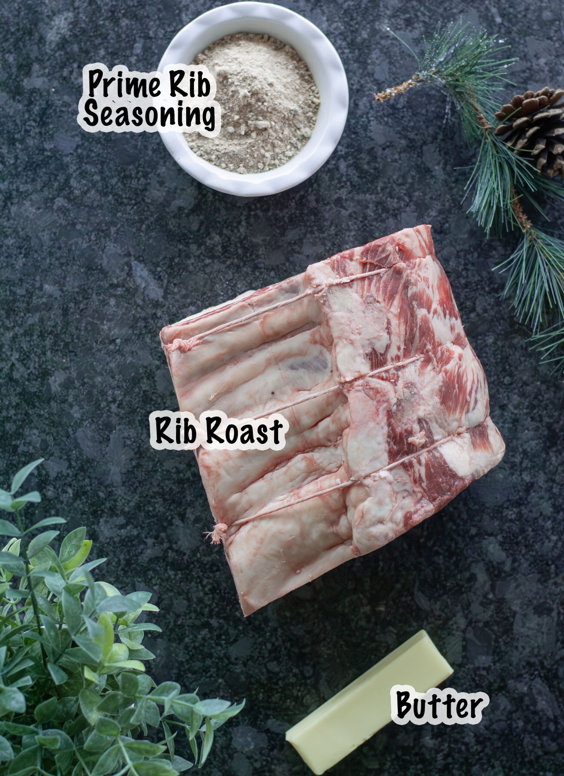 A prime rib, a stick of butter and a bowl of prime rib seasoning.