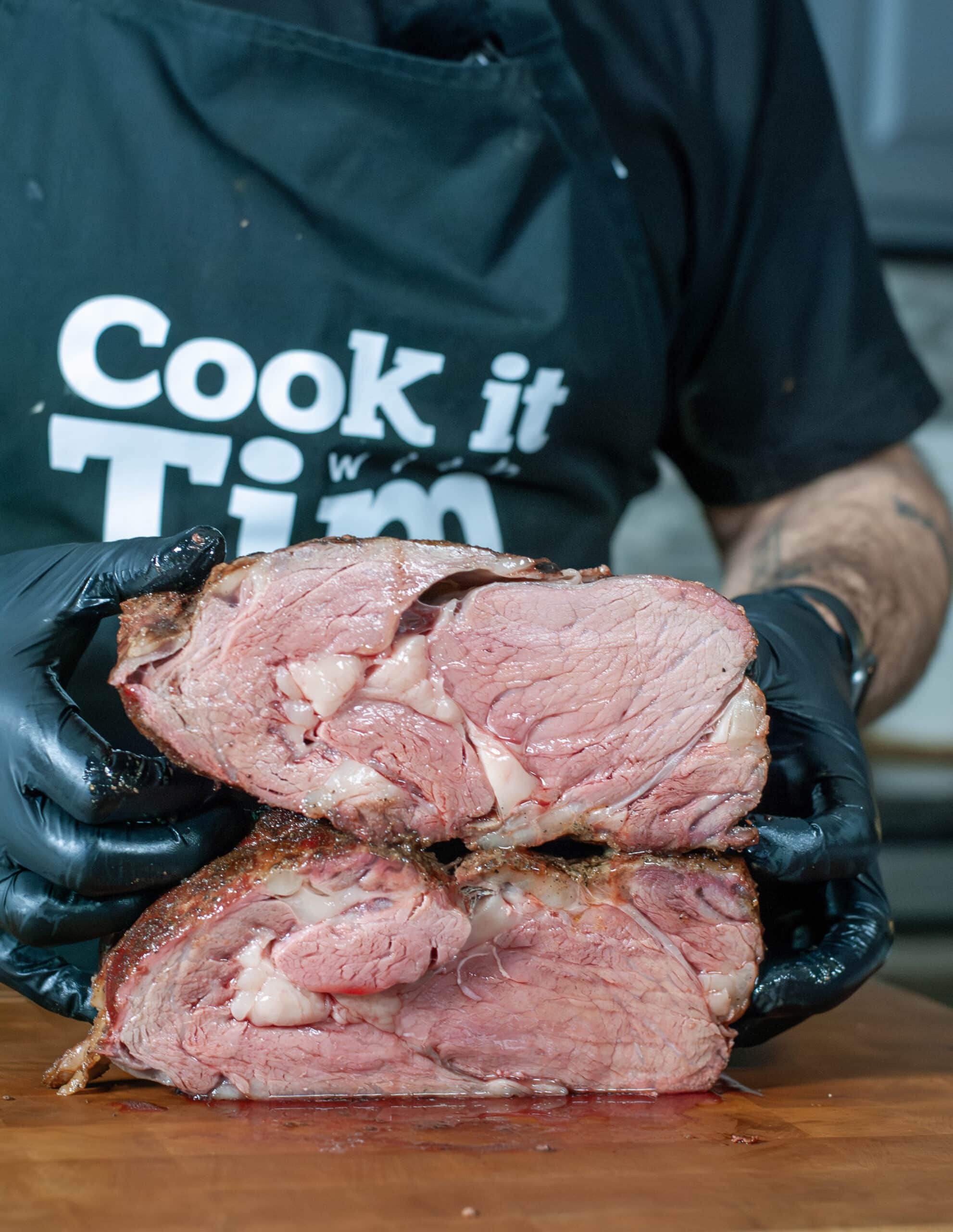 A prime rib cut in half to show the medium rare cook.