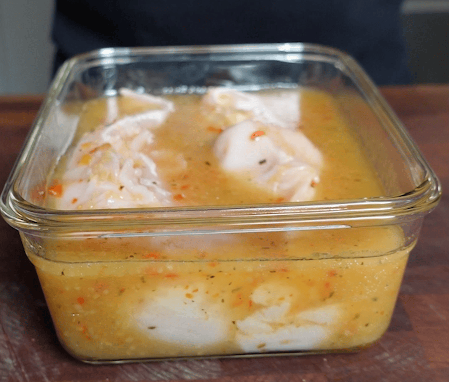 Chicken marinating in Italian dressing.