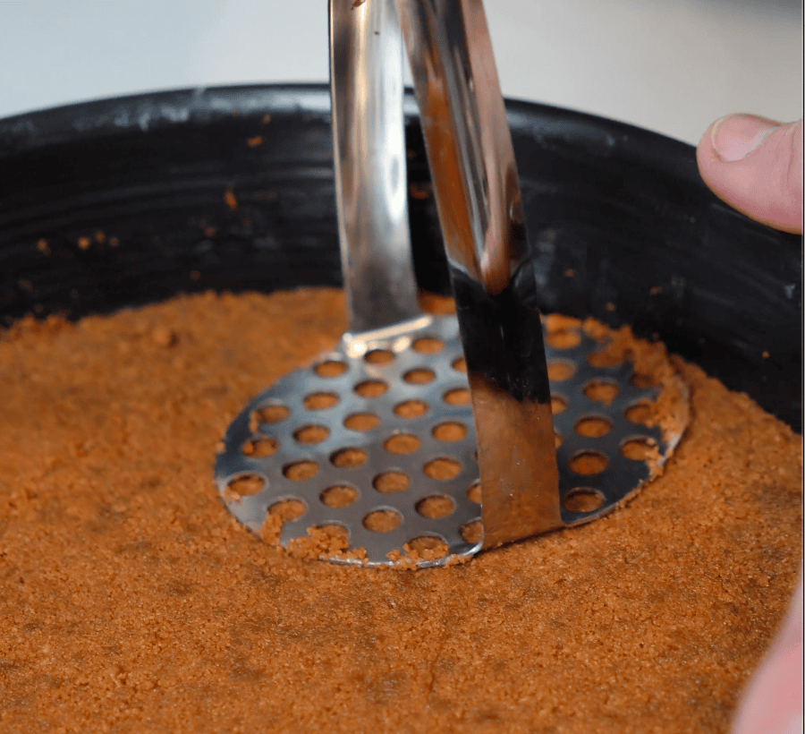Pressing down cheesecake crust.