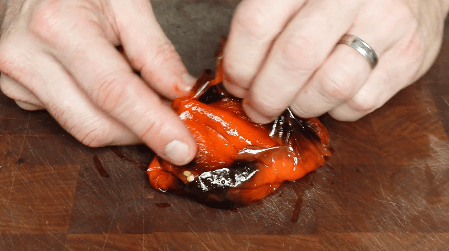 Peeling skin off of pepper.
