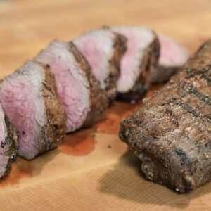 Venison backstrap on cutting board.