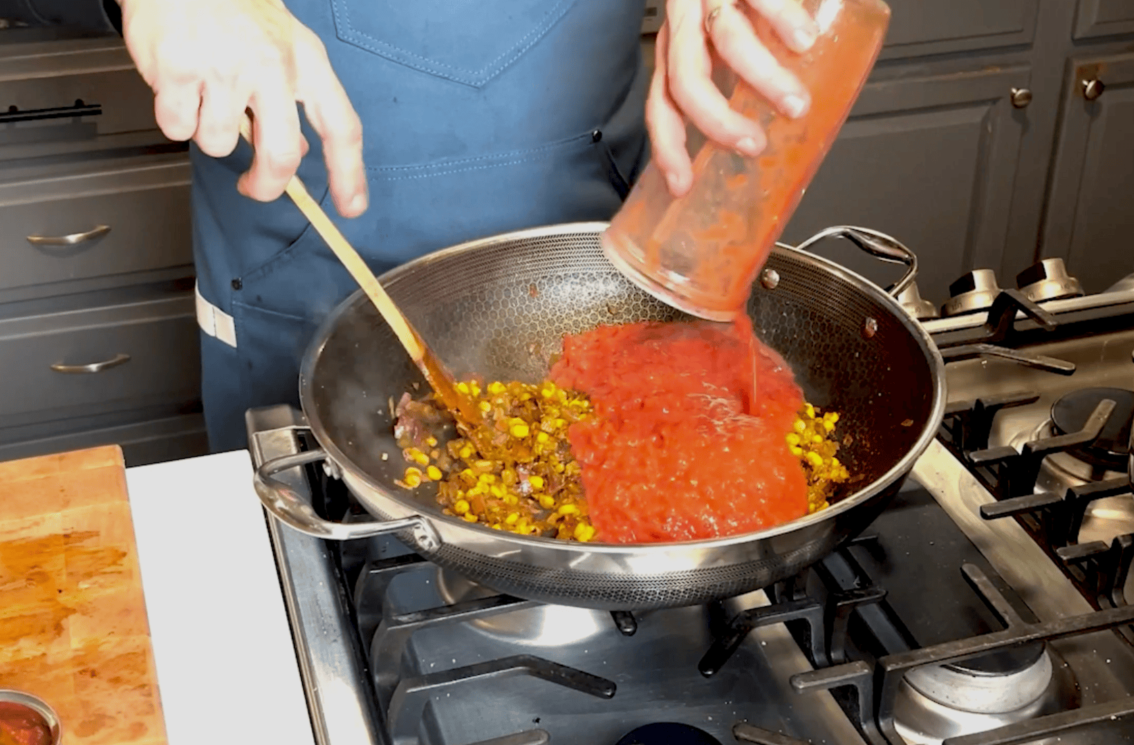 Tomatoes going in skillet.