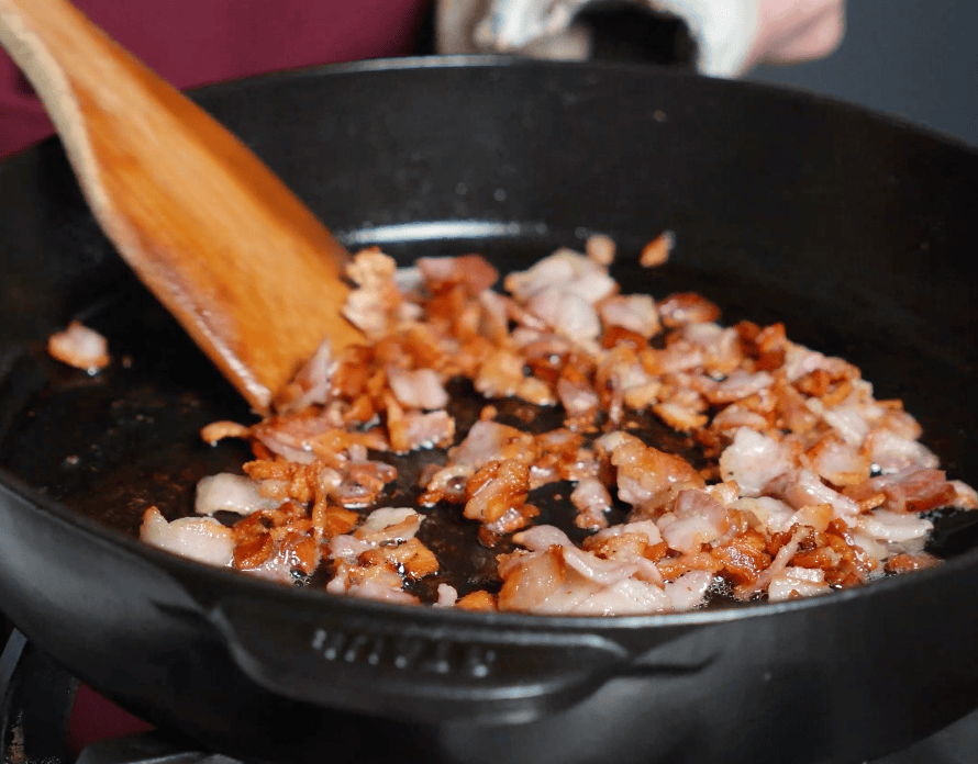 Bacon cooking in skillet.