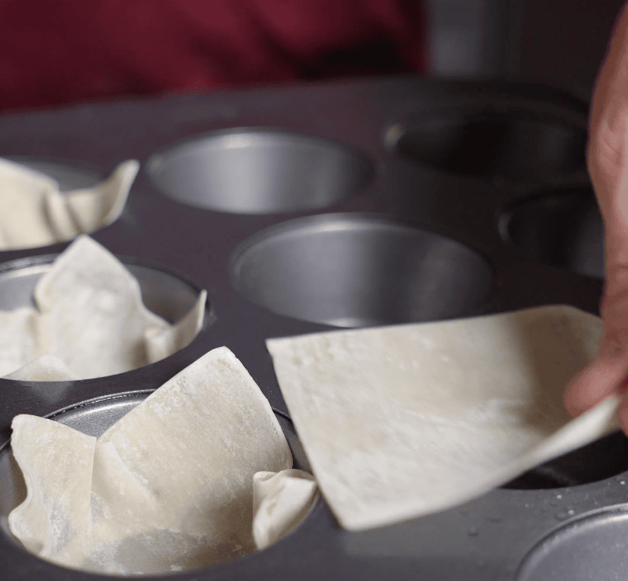 Wonton wrappers going into pan.