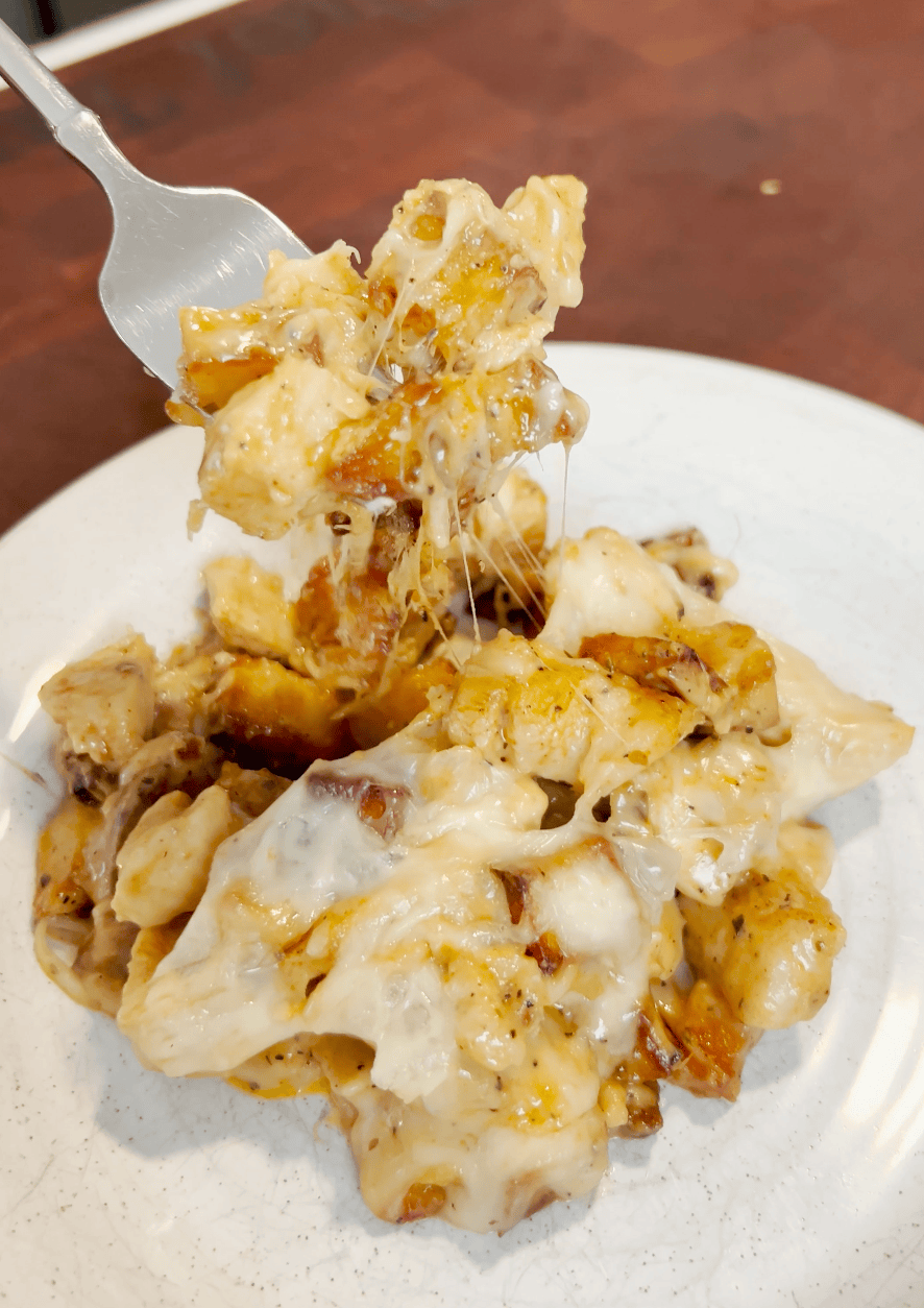 A plate of chicken and parm with a fork.