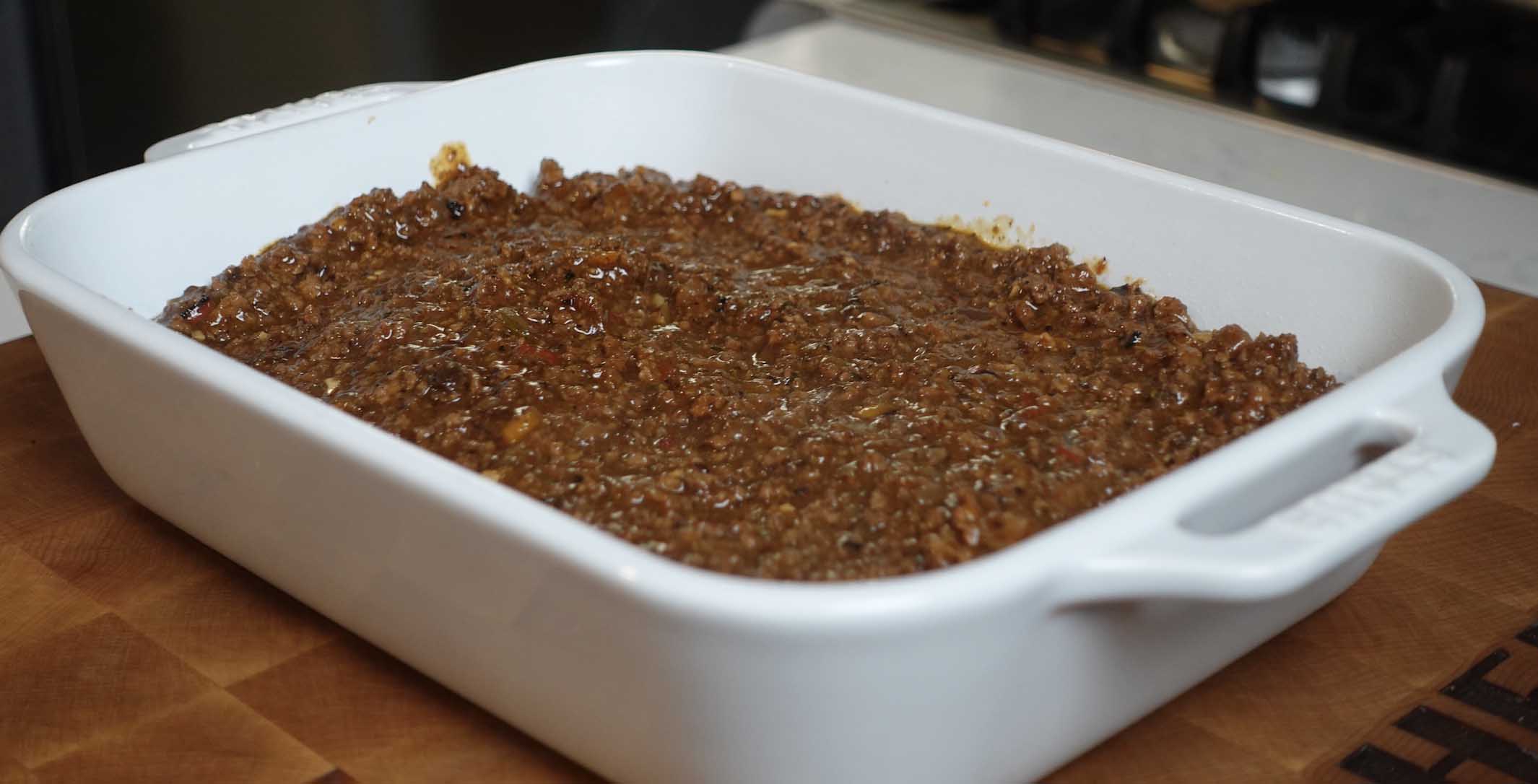 A layer of meat in a baking dish.