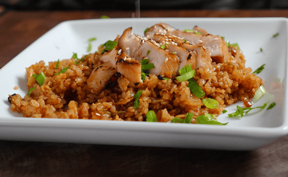 A plate of fried rice with pork.
