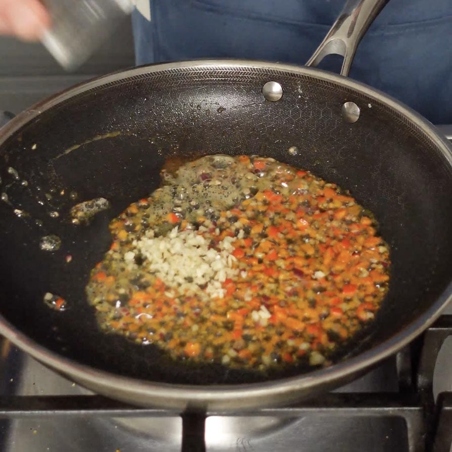 Peppers and garlic in a skillet.
