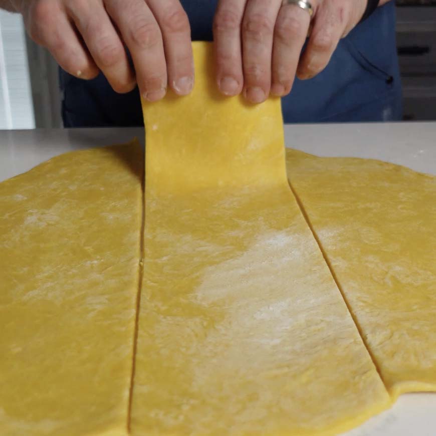 Cutting pasta into sheets.