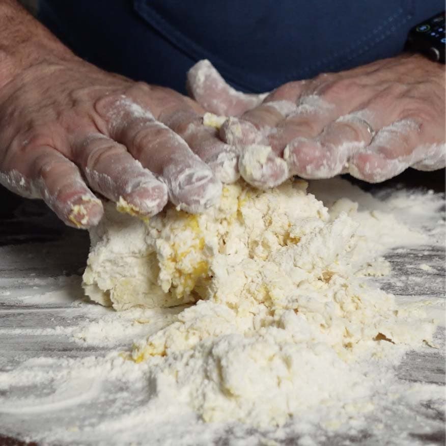 Folding the dough to mix with eggs.