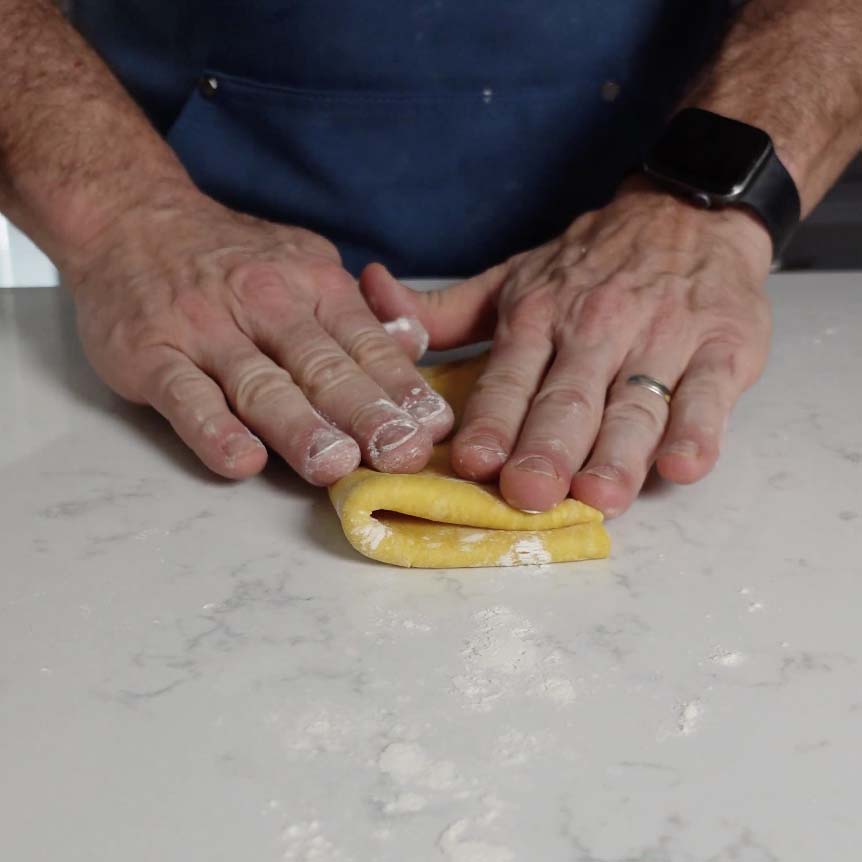 Folding pasta dough.
