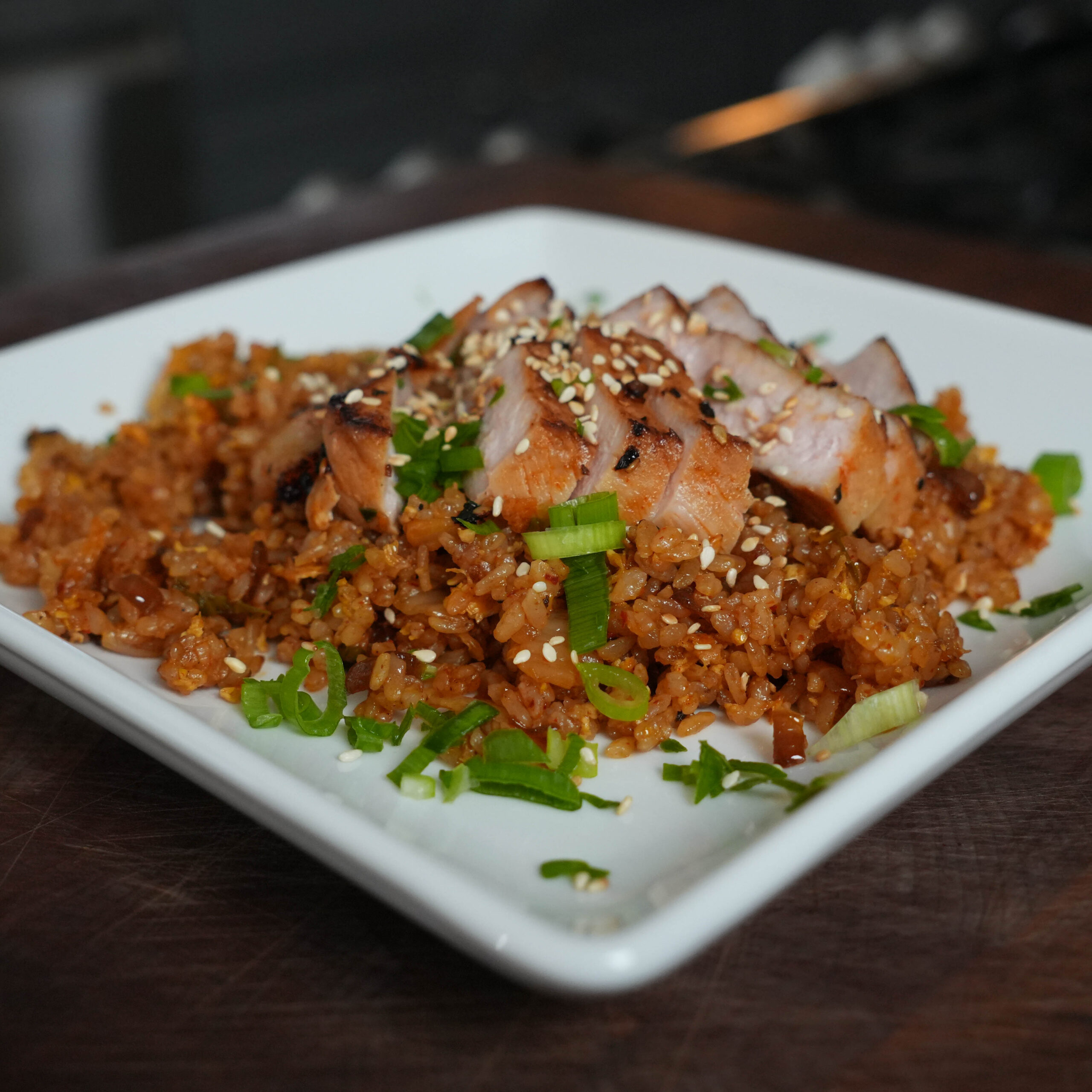 Pork over a bed of fried rice.