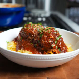 Spaghetti Squash and Meatballs in a bowl with basil.
