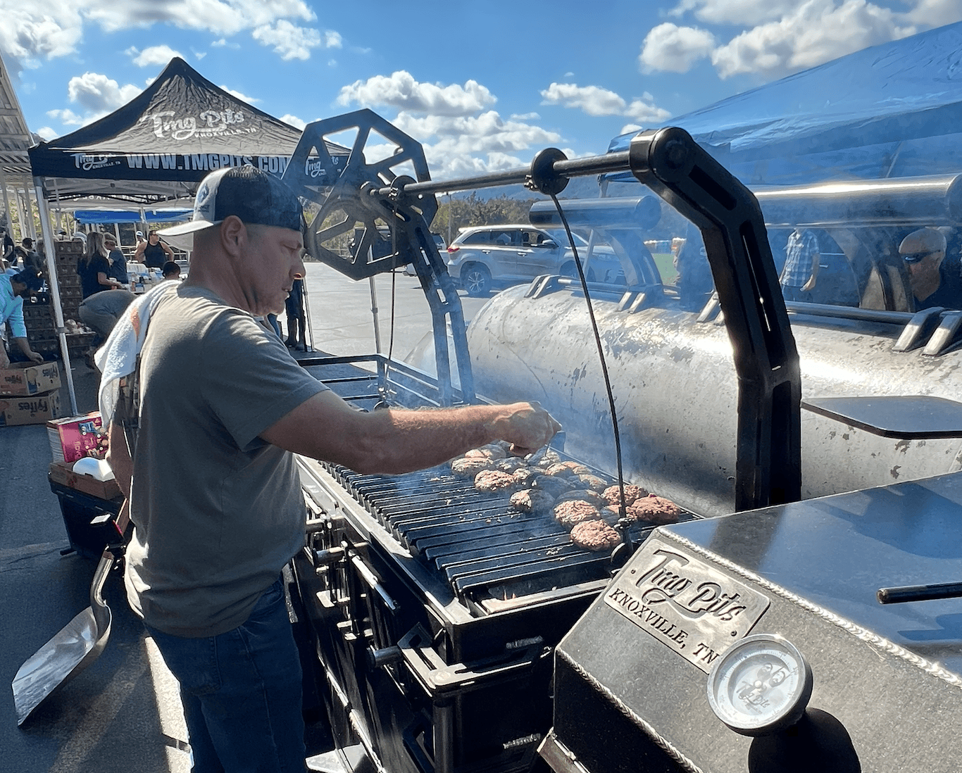 Tim cooking over a smoker.