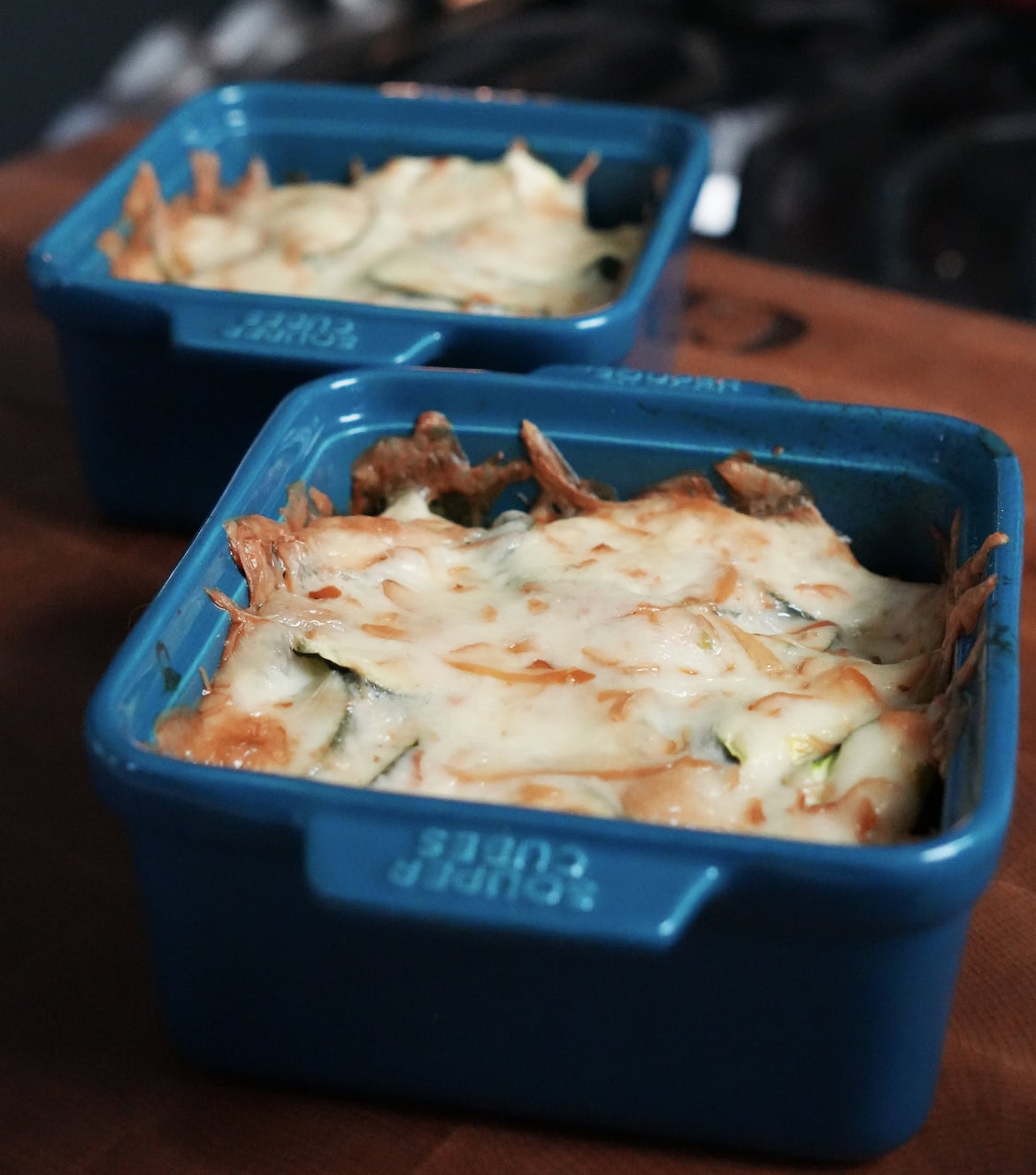 baked chicken and zucchini dinner in casserole dish. 