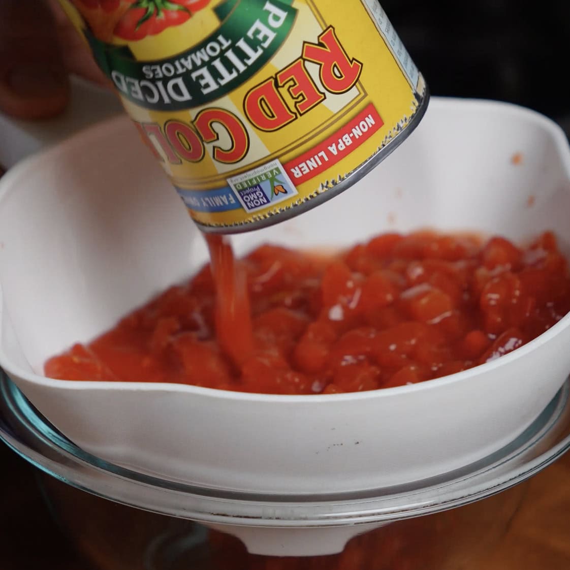draining canned tomatoes for chicken and zucchini casserole