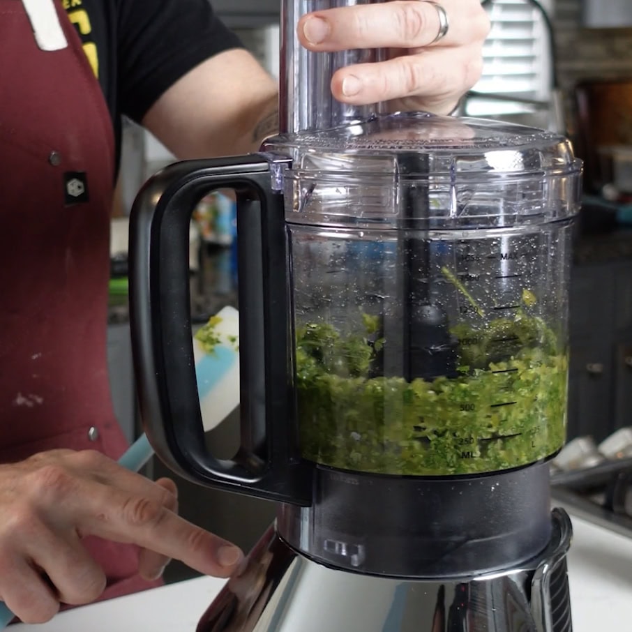 Blending jalapeños and cilantro for ranch dip.