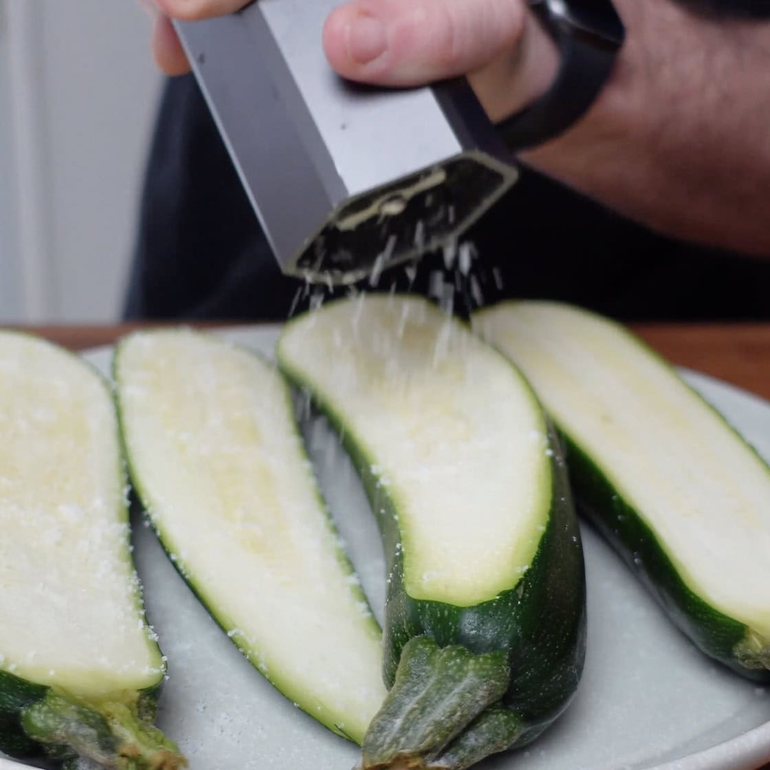 Zucchini being salted to draw moisture from it.  