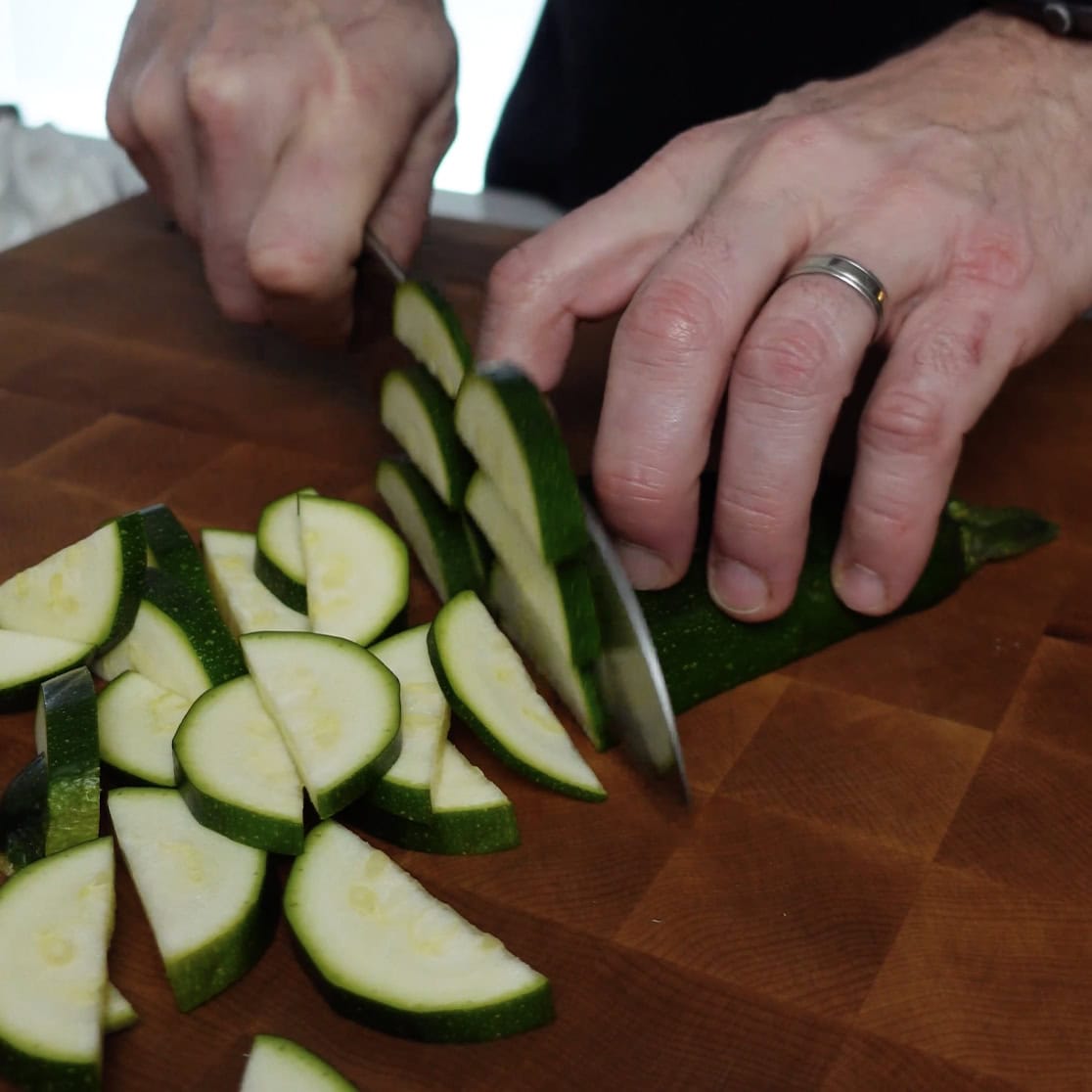 Zucchini being chopped ready to go in chicken and zucchini casserole 