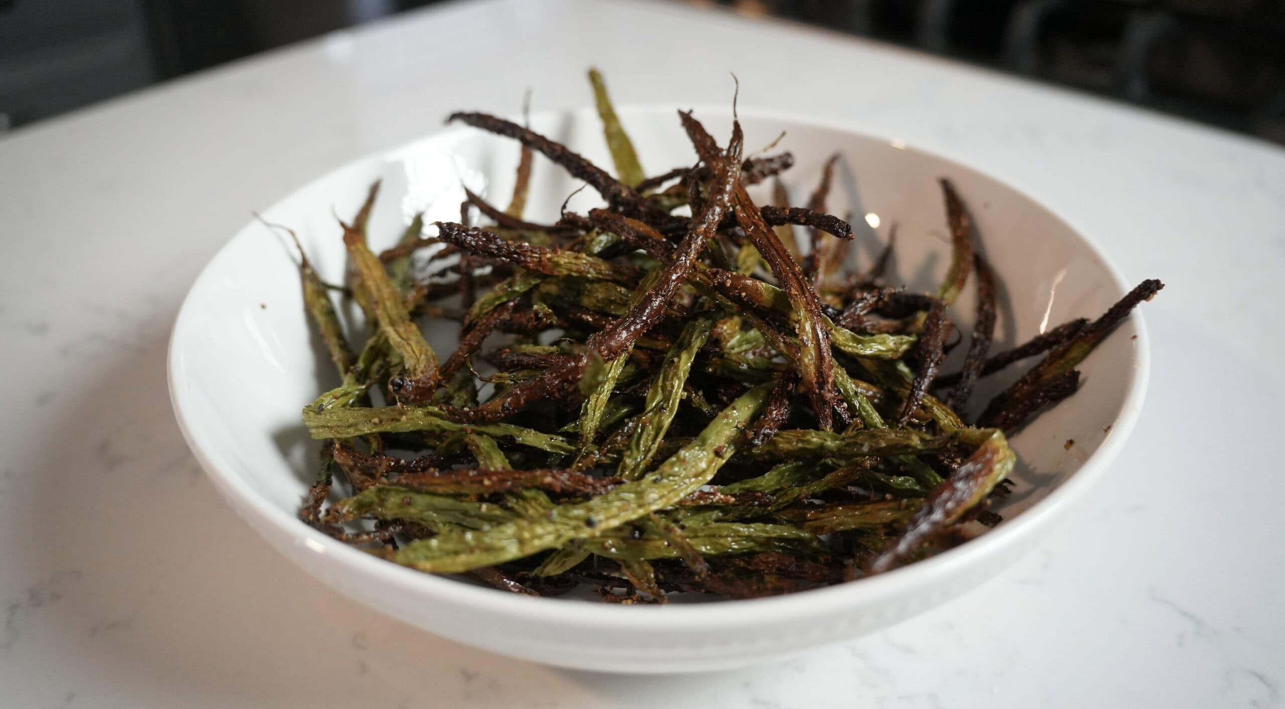 Green beans in a white bowl.