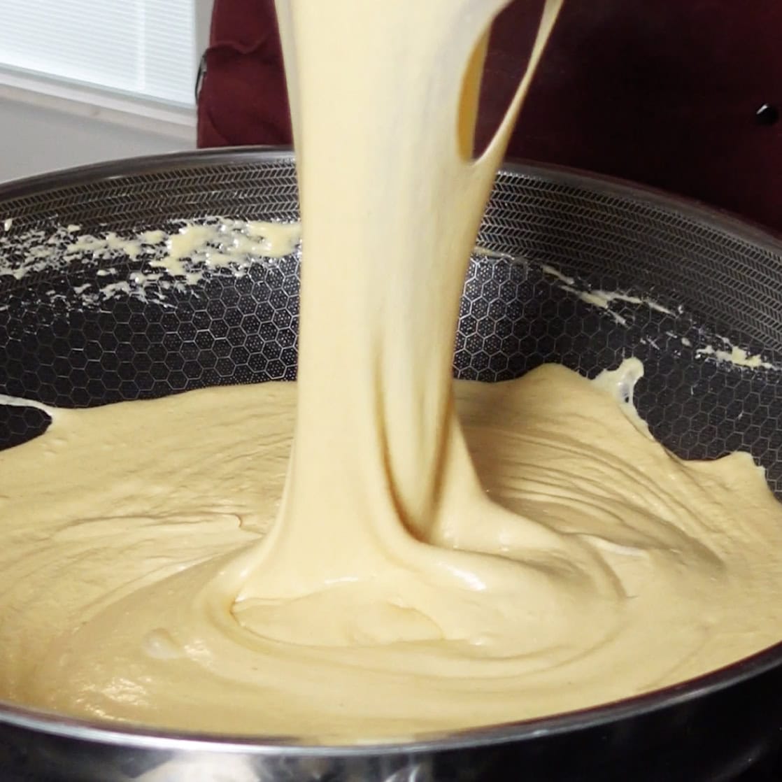 Melted creamy cheese in a skillet.