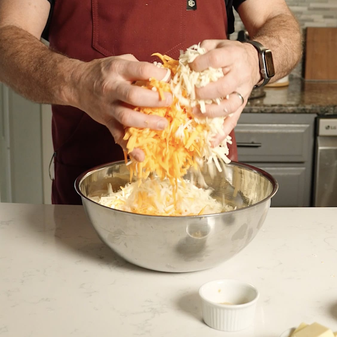 A bowl full of shredded cheese.