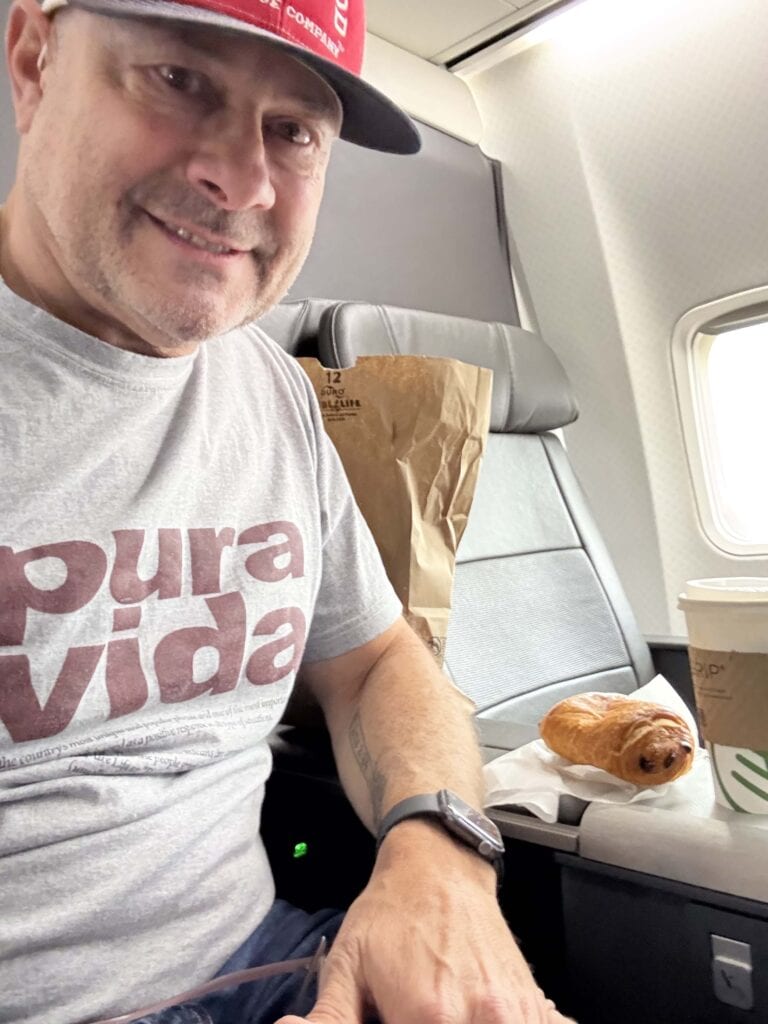 Tim with a pastry on a plane.