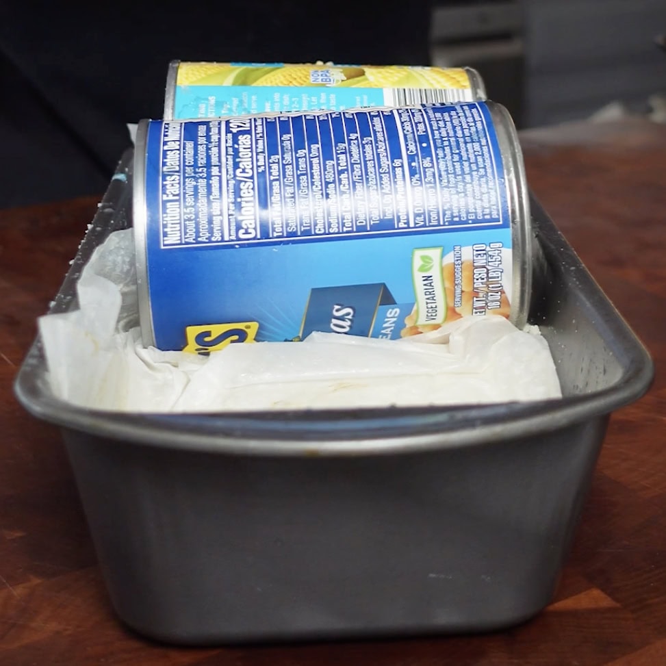Potatoes in a meatloaf pan that were removed from the refrigerator.